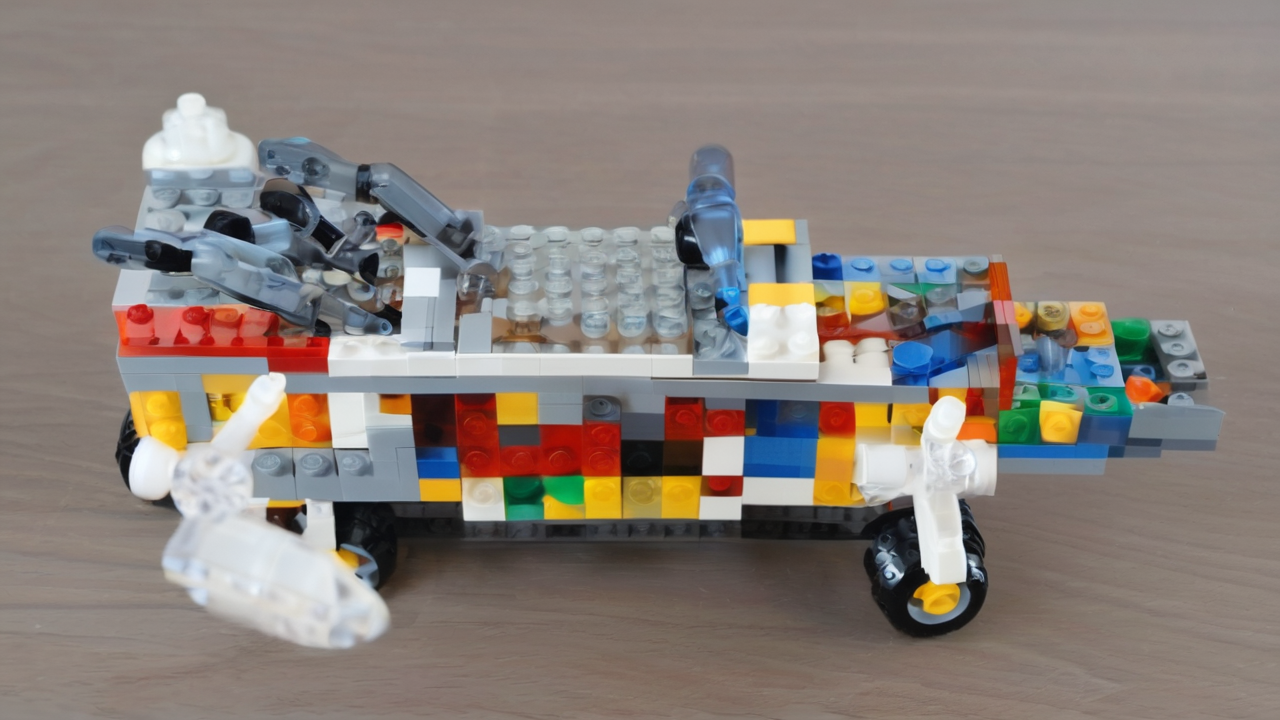 Kolorowe klocki LEGO rozłożone na stole z instrukcją montażu i częściowo zbudowanym modelem